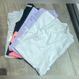 Four Nike sleeveless tops.